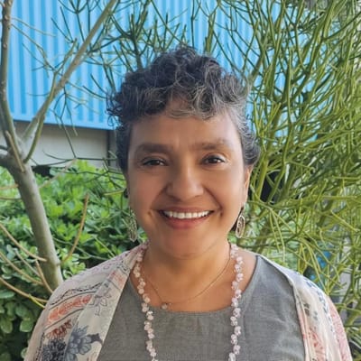 Smiling woman outdoors in a garden setting