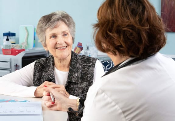 A resident and staff member engaged in conversation
