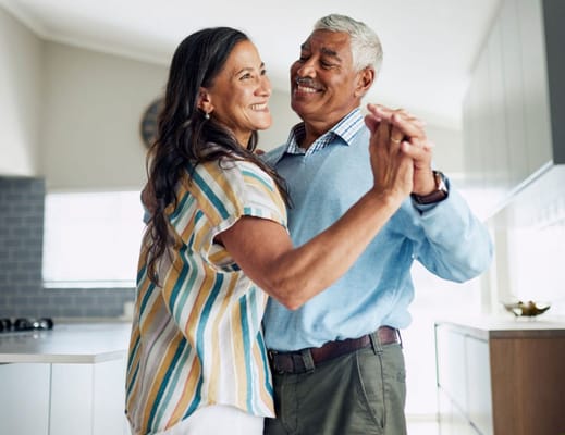Couple dancing joyfully in a bright room