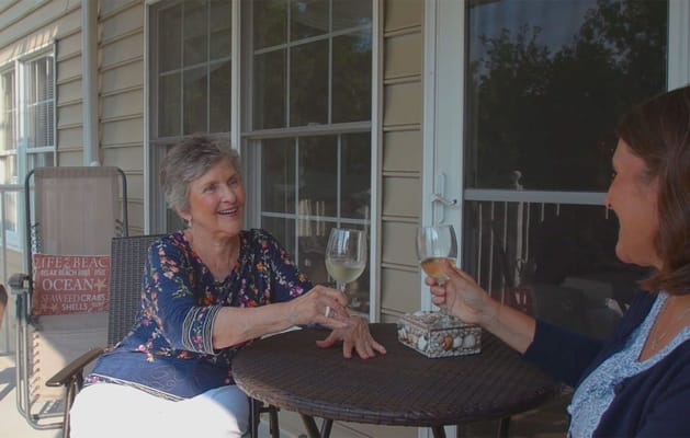 Two residents enjoying drinks on a patio