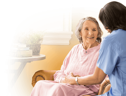 A caregiver interacting with a resident in a cozy setting