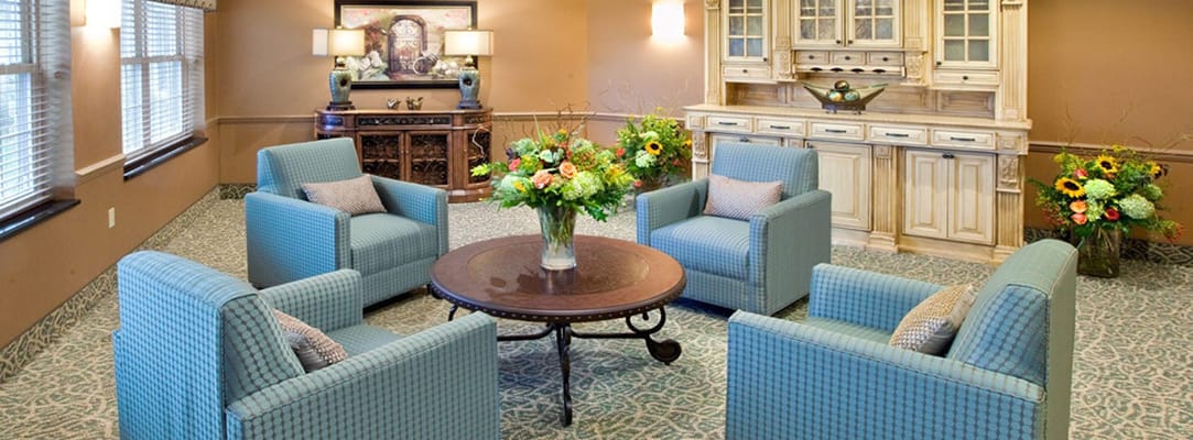 Cozy common area with comfortable seating and floral arrangements