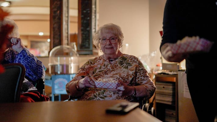 Resident enjoying a snack in a cozy setting