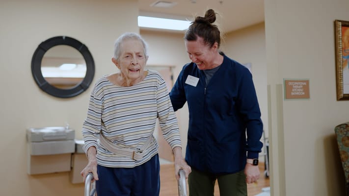 Staff member assisting a resident in a common area