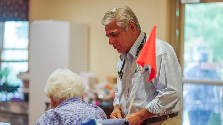 A doctor assisting a resident in a facility