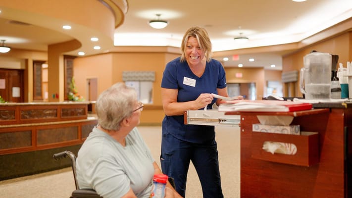 Staff member interacting with a resident in a common area