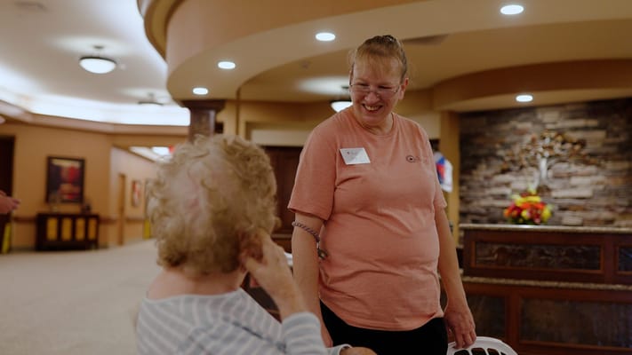 Staff member interacting with a resident in a common area