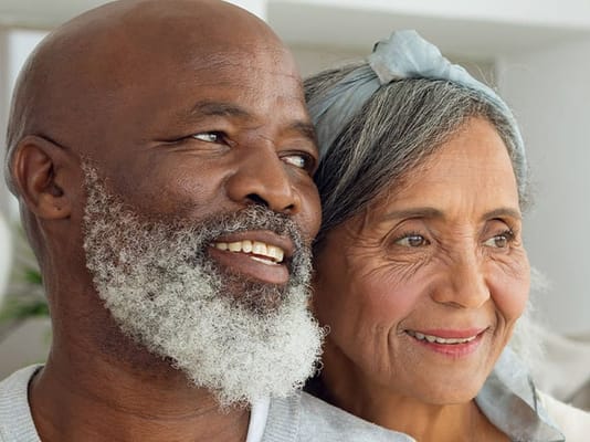 An older couple smiling warmly together