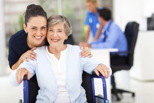 Caregiver and resident smiling in a facility