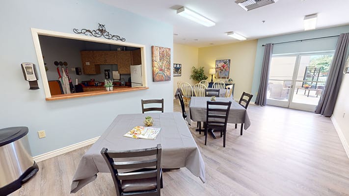 Bright common area with dining tables and decor