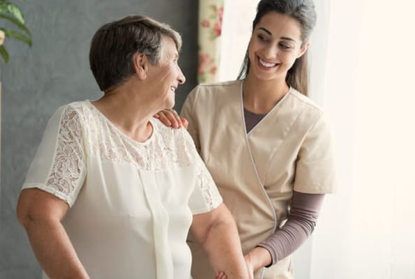 Caregiver assisting a senior resident in a bright room