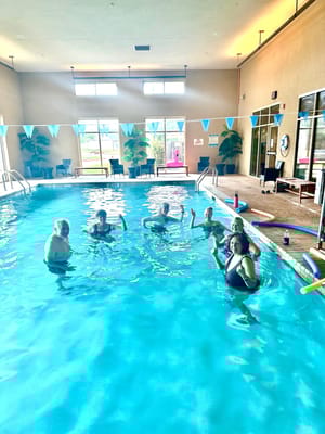 Residents enjoying a swimming activity in an indoor pool