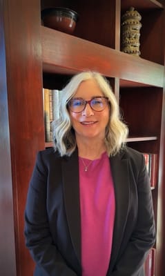 Staff member posing in a welcoming interior space