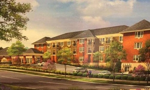 Exterior view of a senior living facility with landscaped surroundings