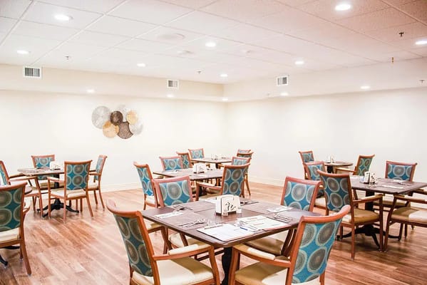 Dining room with tables and chairs set up for meals