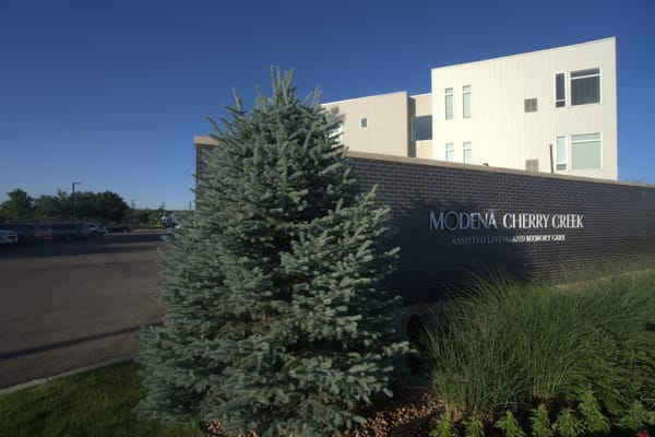 Exterior view of Modena Cherry Creek with signage