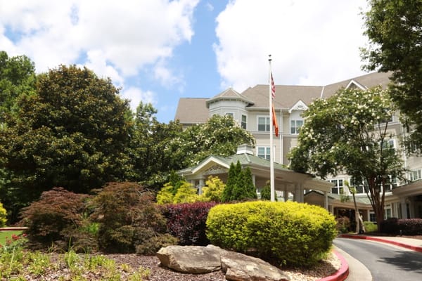 Front entrance of Sunrise at Buckhead with landscaped gardens