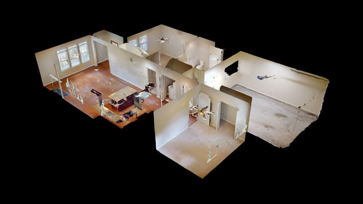 Spacious living area with hardwood floors and modern kitchen