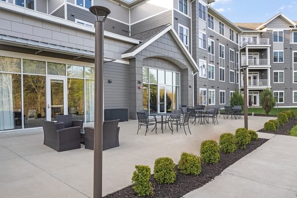 Exterior view of a nursing home patio with seating area