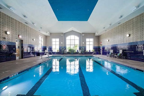 Indoor swimming pool with seating area