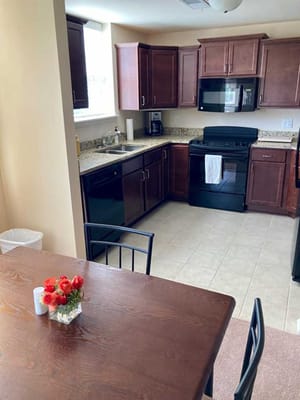 Modern kitchen with dining area in a senior facility