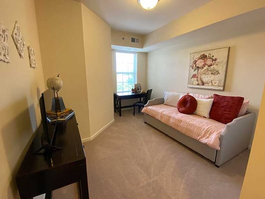 Cozy resident room with a sofa and desk