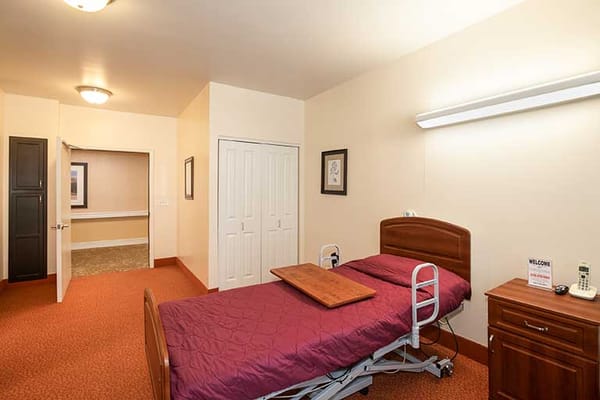Interior view of a private resident room with a bed