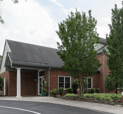Exterior view of the Arden Courts facility with surrounding greenery.