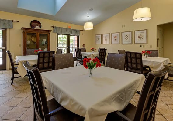 Bright dining area with tables and flower centerpieces