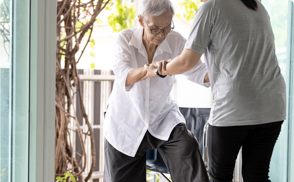 Staff assisting a resident in a bright indoor space