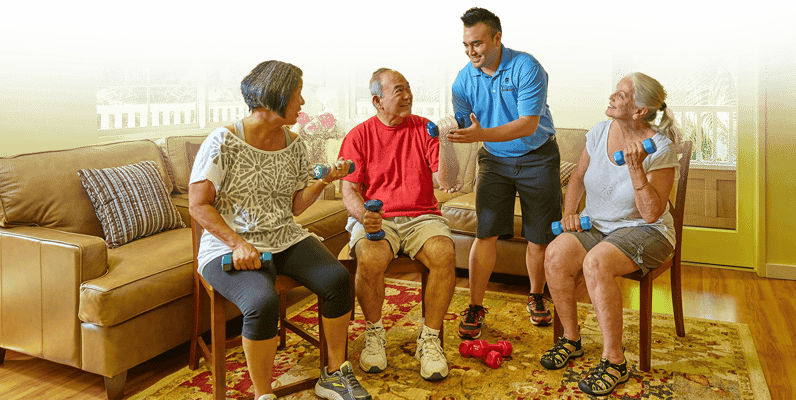 Residents participating in a fitness activity with a staff member