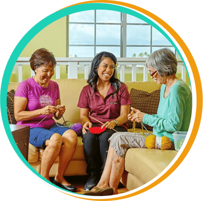 Residents and staff engaging in a knitting activity