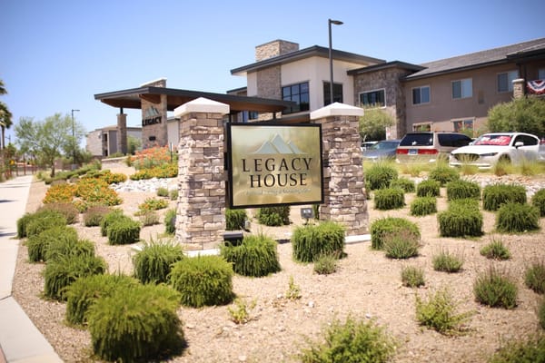 Exterior view of Legacy House sign and landscaping