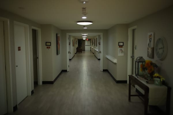 Long hallway with doors and artwork