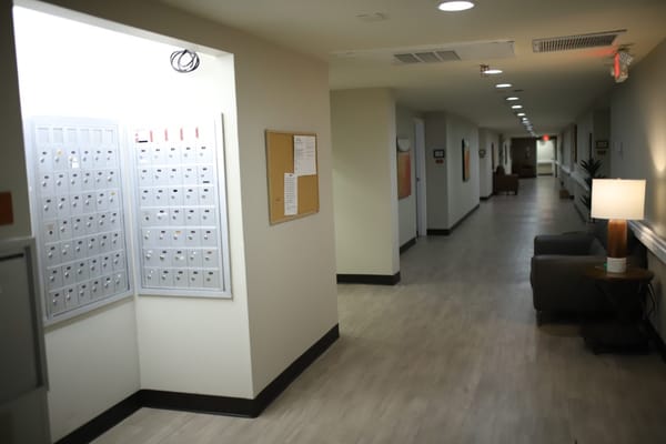 Hallway with mailboxes and seating area in Sterling Ridge Senior Living