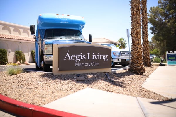Sign and facility shuttle in front of Aegis Living