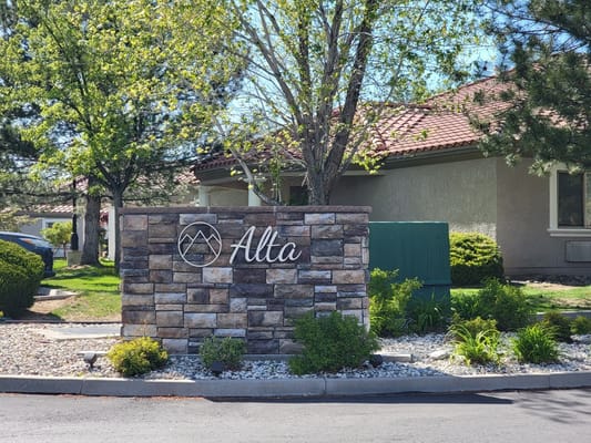 Facility entrance sign with landscaped surroundings