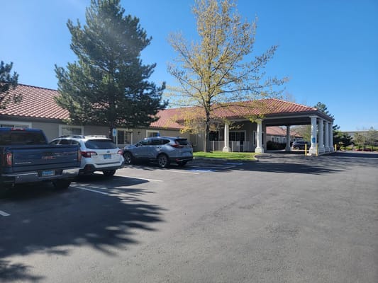 Exterior view of a senior living facility with parking
