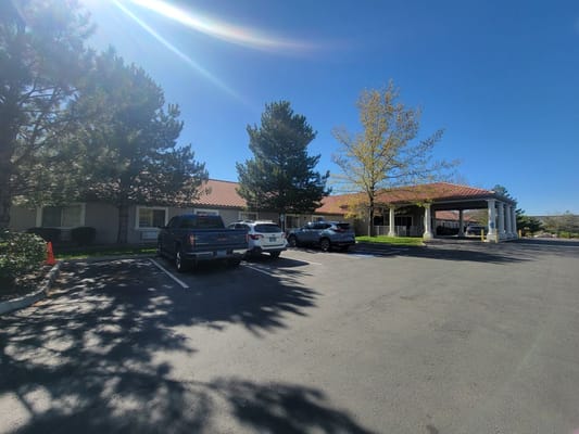 Exterior view of a senior living facility with parking lot