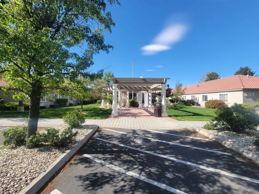 Entrance of a senior living facility with gardens
