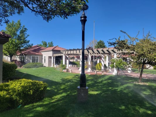 Exterior view of a senior living facility with gardens