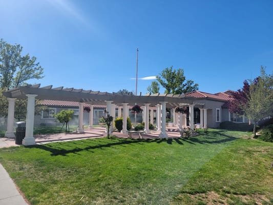 Outdoor patio area with pergola and landscaping