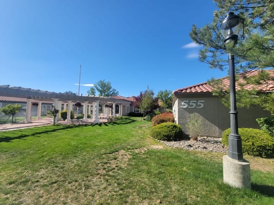 Exterior view of a senior living facility with gardens