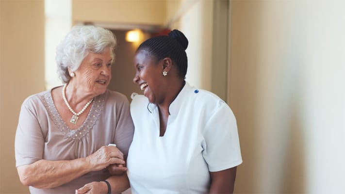 A caregiver and resident sharing a joyful moment
