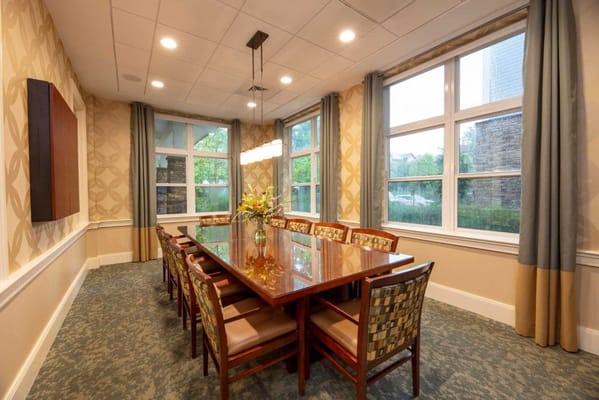 Bright dining room with a large table and flowers
