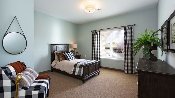 A cozy resident room with a bed and decor