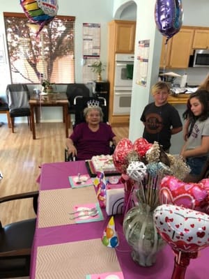 Residents celebrating a birthday with decorations and cake