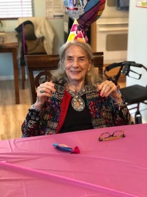 Resident celebrating a birthday in a decorated common area