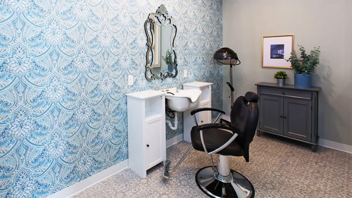 Hair salon station with a mirror and chair