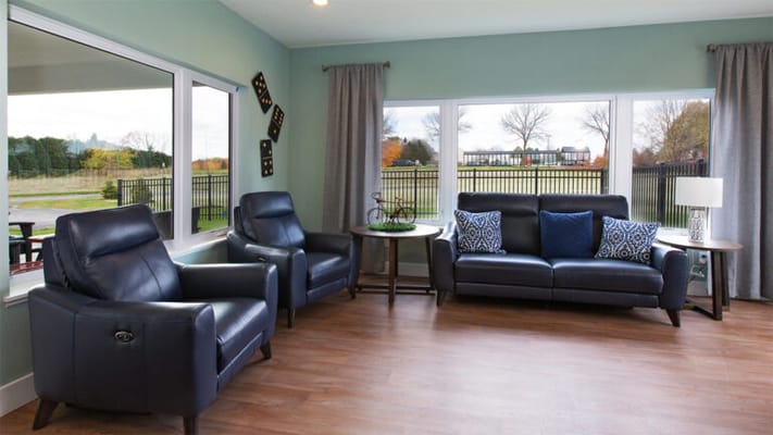 Bright common area with seating and large windows